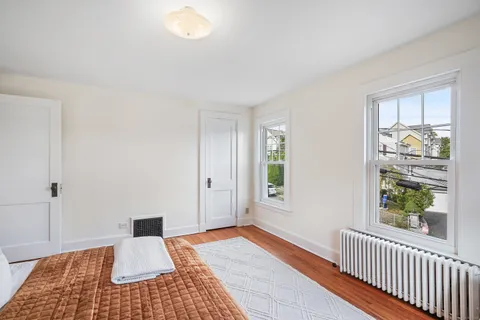 a bedroom with a bed and a window