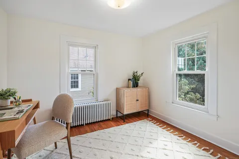a bedroom with furniture and a window