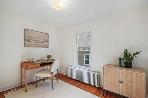 a dining room with furniture and wooden floor