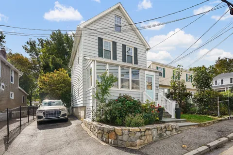 a view of a car park in front of a house
