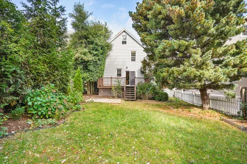 a view of a house with a yard and sitting area