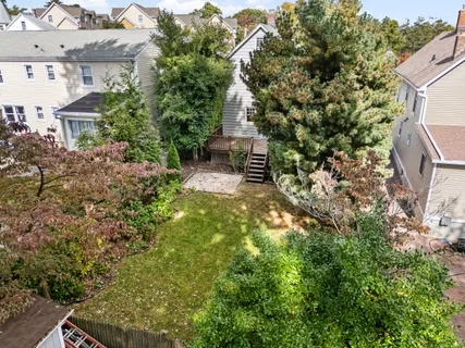 a aerial view of a house with a yard and sitting area