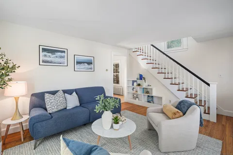 a living room with furniture and a dining table