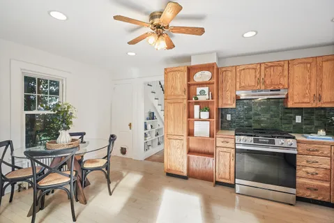 a kitchen with stainless steel appliances granite countertop a stove and a refrigerator
