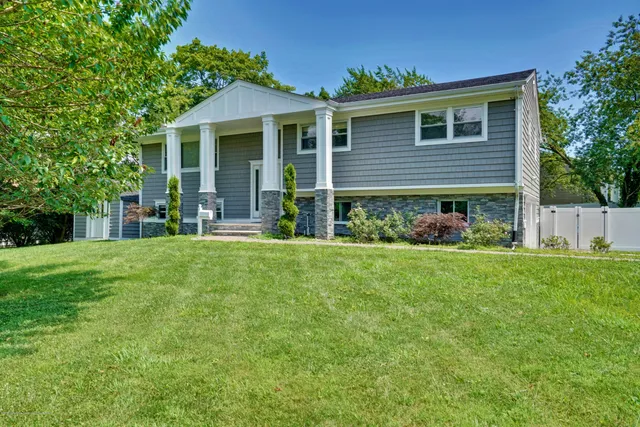 a front view of house with yard and green space