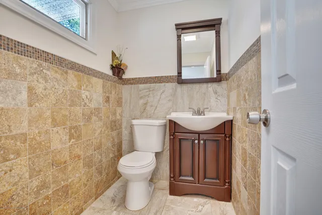 a bathroom with a sink a toilet and mirror
