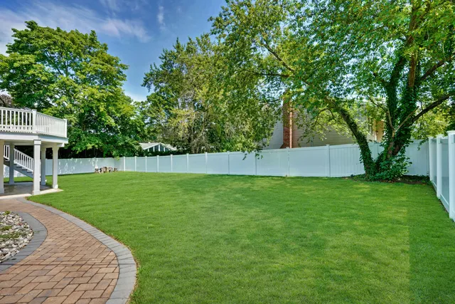 a swimming pool with lots of green space