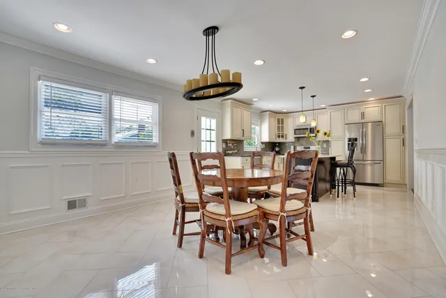 a view of a dining room with furniture and chandelier