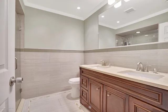 a bathroom with a granite countertop sink a toilet and a mirror