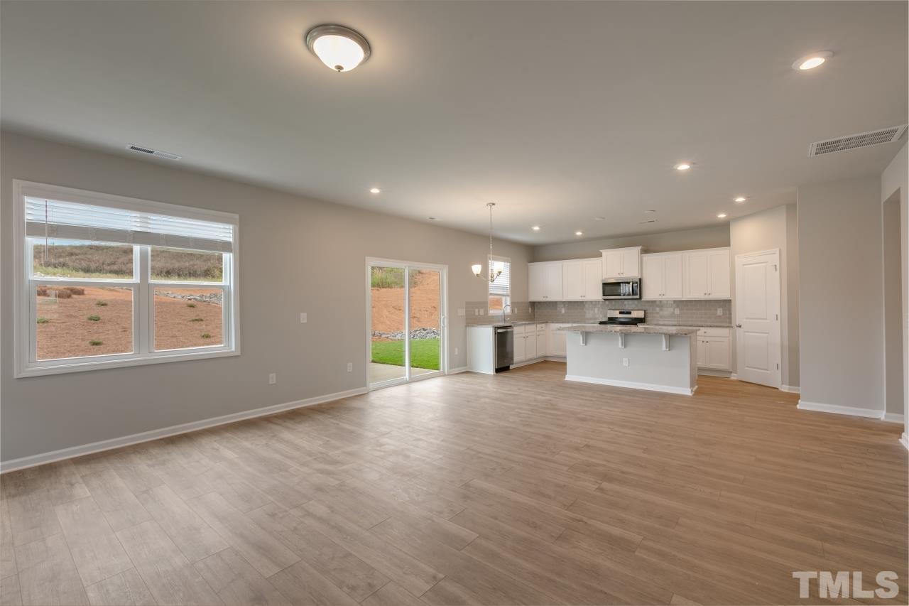 249 Pierce Lndg Drive Garner, NC 27529 - Photo 7 of 11 a view of kitchen with kitchen island wooden floor center island and stainless steel appliances