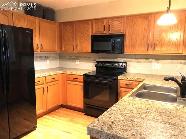 3575 Indigo Ridge Point Colorado Springs, CO 80910 - Photo 8 of 27 Granite tile, hardwood floors