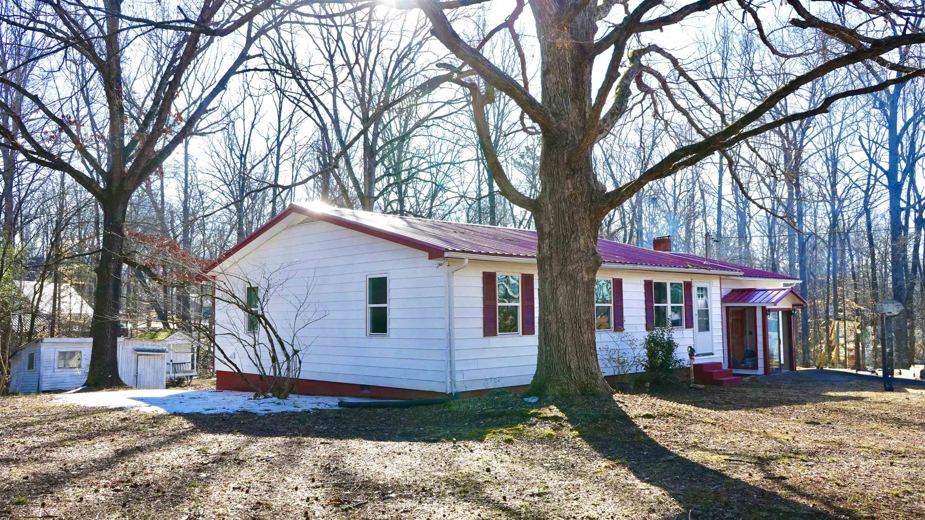 120 Rhodes Drive Middleton, TN 38052 - Photo 7 of 16 View of property exterior featuring a metal roof, a chimney, and a shed