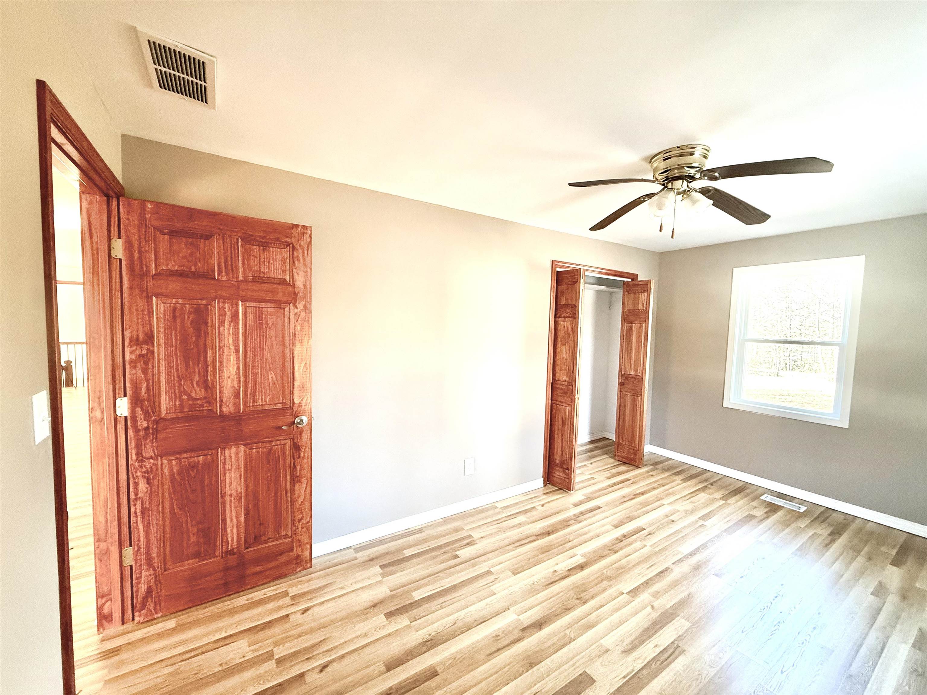 120 Rhodes Drive Middleton, TN 38052 - Photo 9 of 16 a view of a livingroom with a chandelier fan and wooden floor