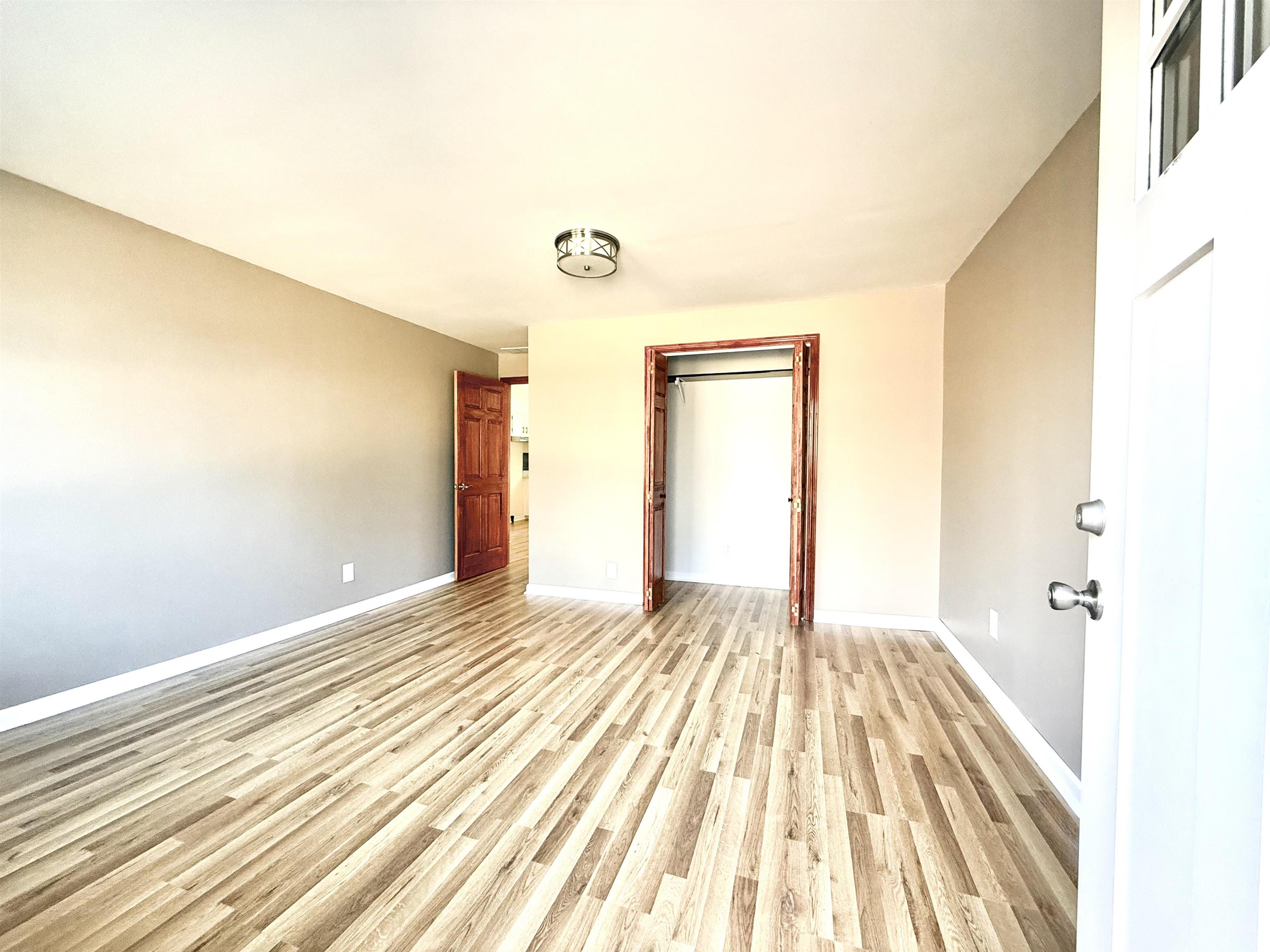 120 Rhodes Drive Middleton, TN 38052 - Photo 10 of 16 a view of a bedroom with wooden floor and bathroom