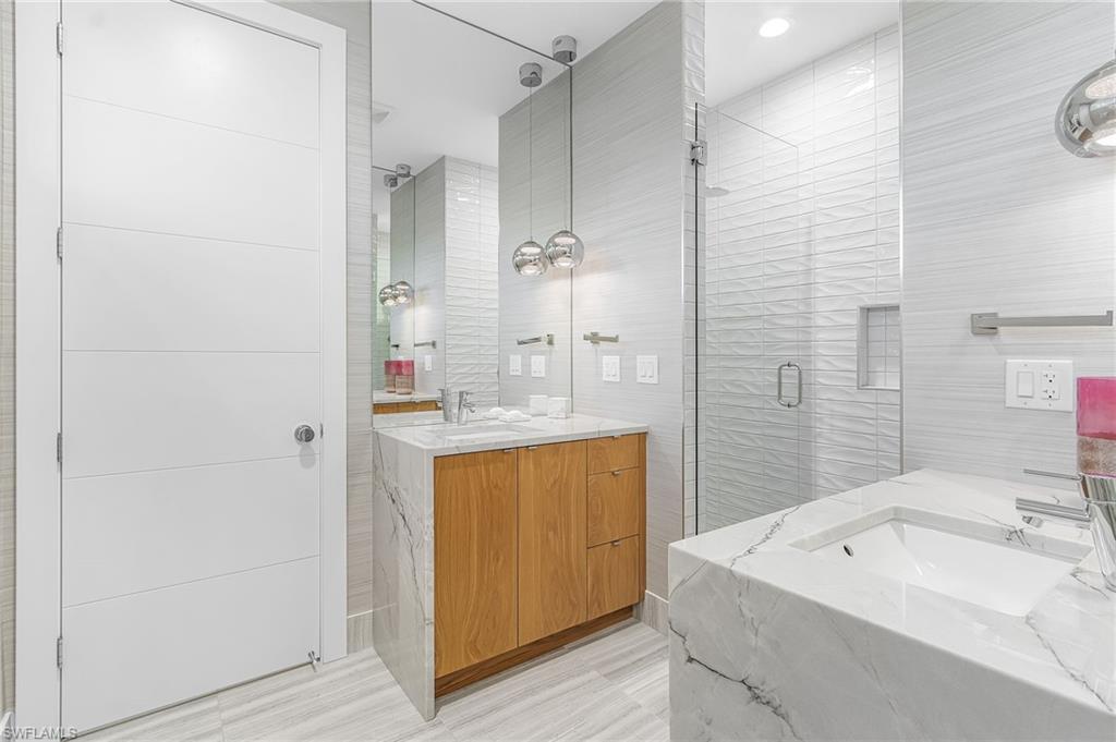 591 93rd Avenue North Naples, FL 34108 - Photo 26 of 35 2nd floor "primary" bath with dual sinks and walk-in shower