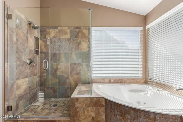 a bathroom with a bathtub and a shower