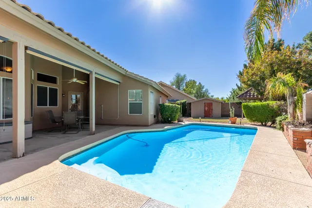 a view of house with swimming pool outdoor seating