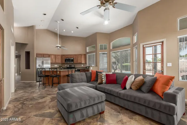 a living room with furniture kitchen and a chandelier