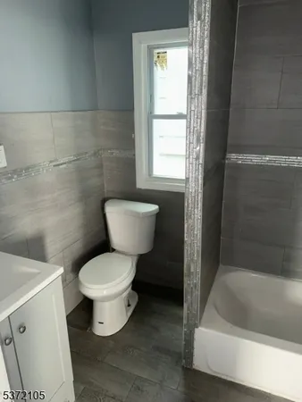 a bathroom with a toilet and a bathtub
