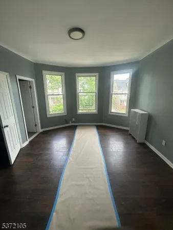 a view of room with window and hardwood floor