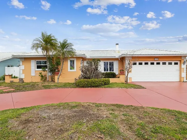 a view of a house with a yard and a garage