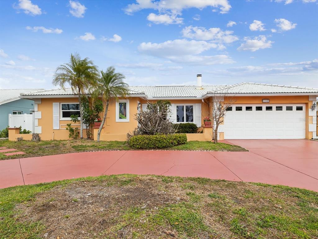 a view of a house with a yard and a garage