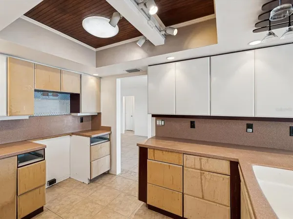 a kitchen with a cabinets and chandelier
