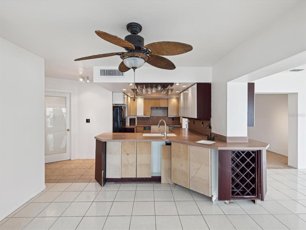 11549 48th Avenue North St. Petersburg, FL 33708 - Photo 13 of 37 a kitchen with a cabinets and chandelier