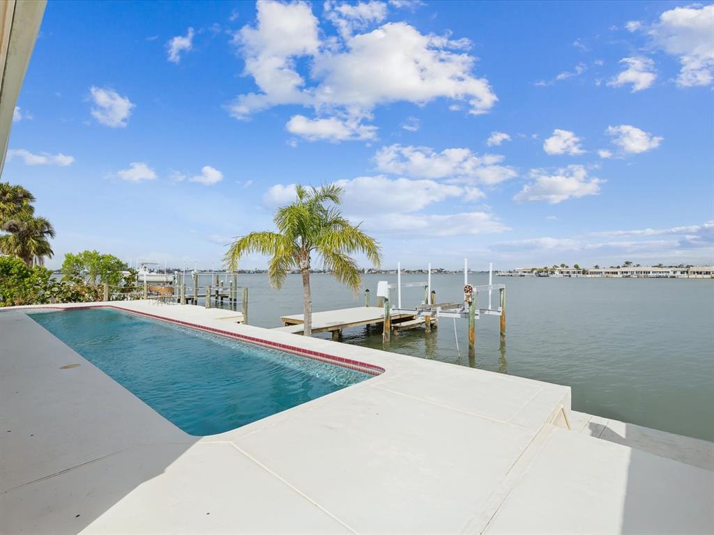 11549 48th Avenue North St. Petersburg, FL 33708 - Photo 24 of 37 a view of a swimming pool with an outdoor seating
