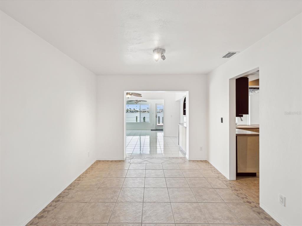 11549 48th Avenue North St. Petersburg, FL 33708 - Photo 6 of 37 a view of a hallway with wooden shelves