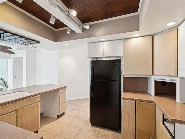 a kitchen with a refrigerator and a stove