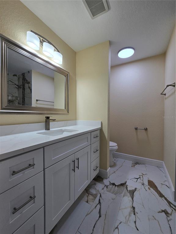 9 Locust Run Track Ocala, FL 34472 - Photo 15 of 38 a bathroom with a double vanity sink and a toilet