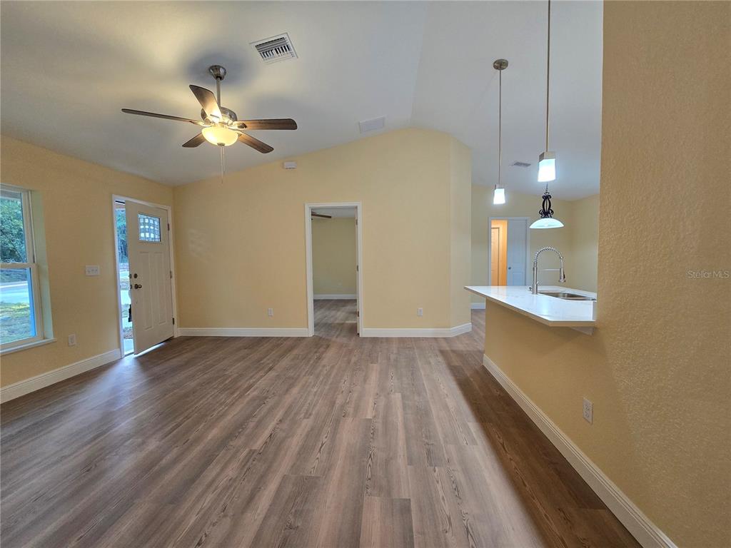 9 Locust Run Track Ocala, FL 34472 - Photo 19 of 38 a view of a room with wooden floor and a ceiling fan