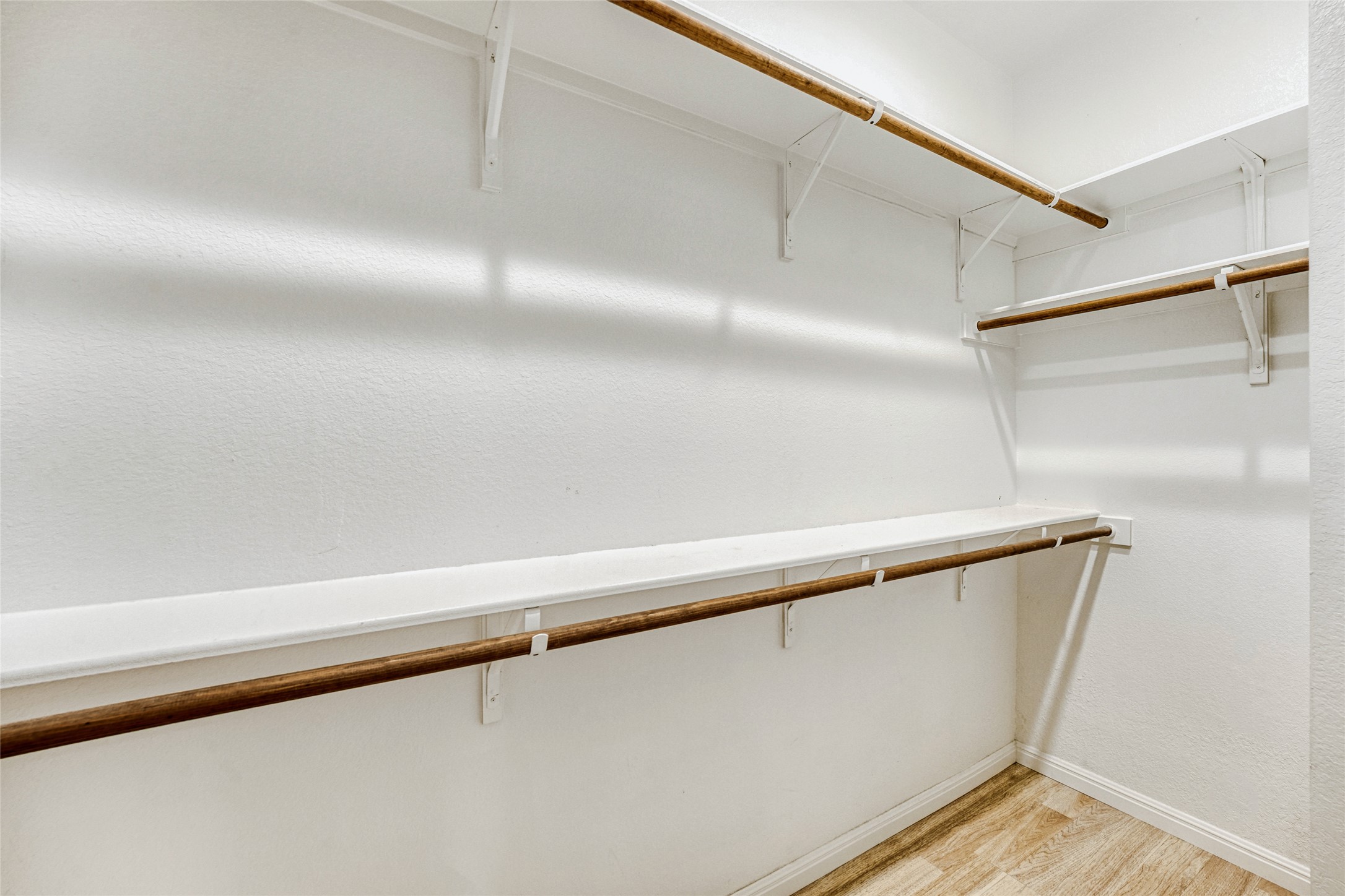 410 Anacua Loop, Unit 30 Manchaca, TX 78652 - Photo 23 of 33 Walk in closet featuring light wood-style floors