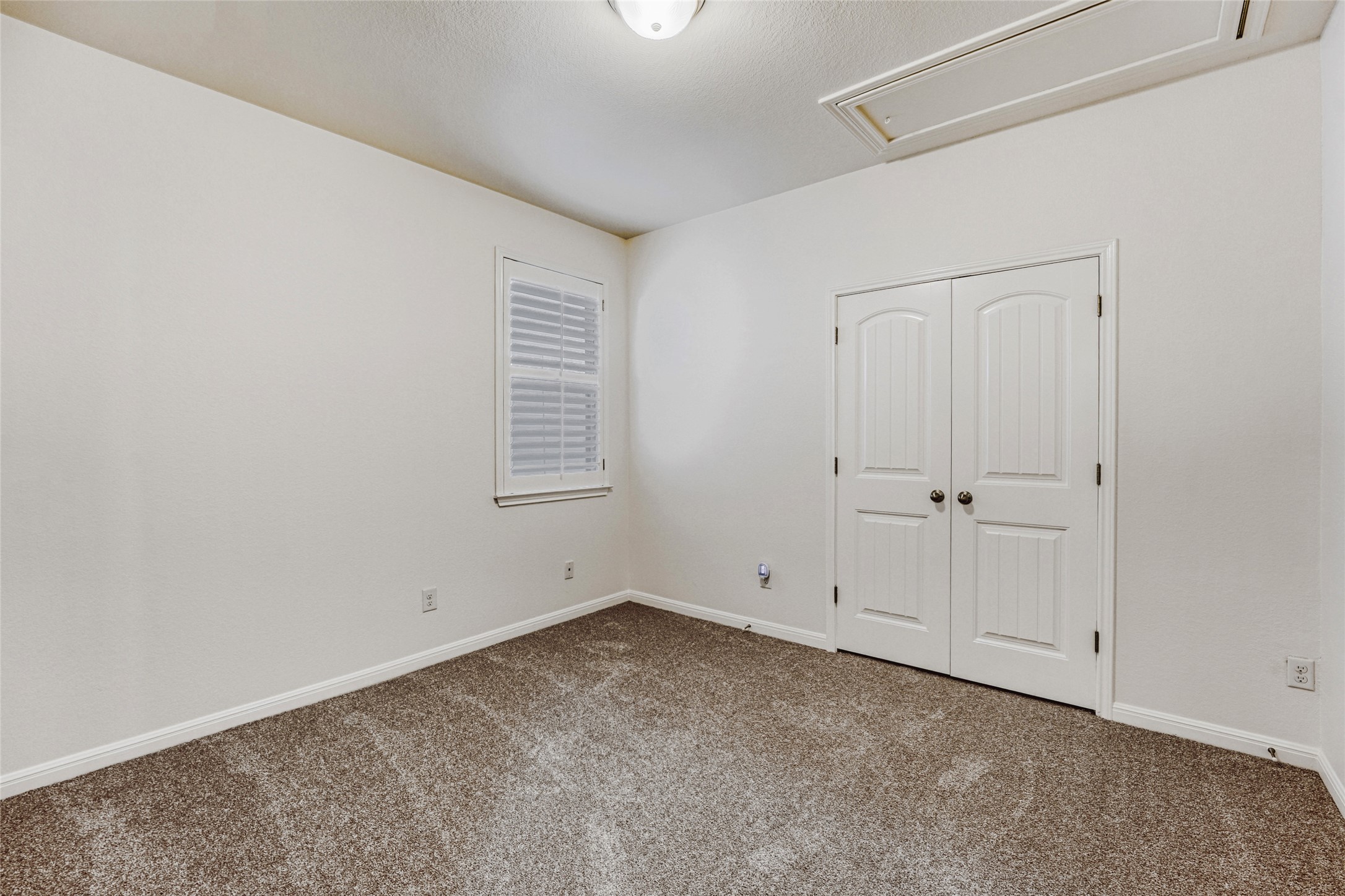 410 Anacua Loop, Unit 30 Manchaca, TX 78652 - Photo 24 of 33 Unfurnished bedroom #2 featuring carpet and a closet