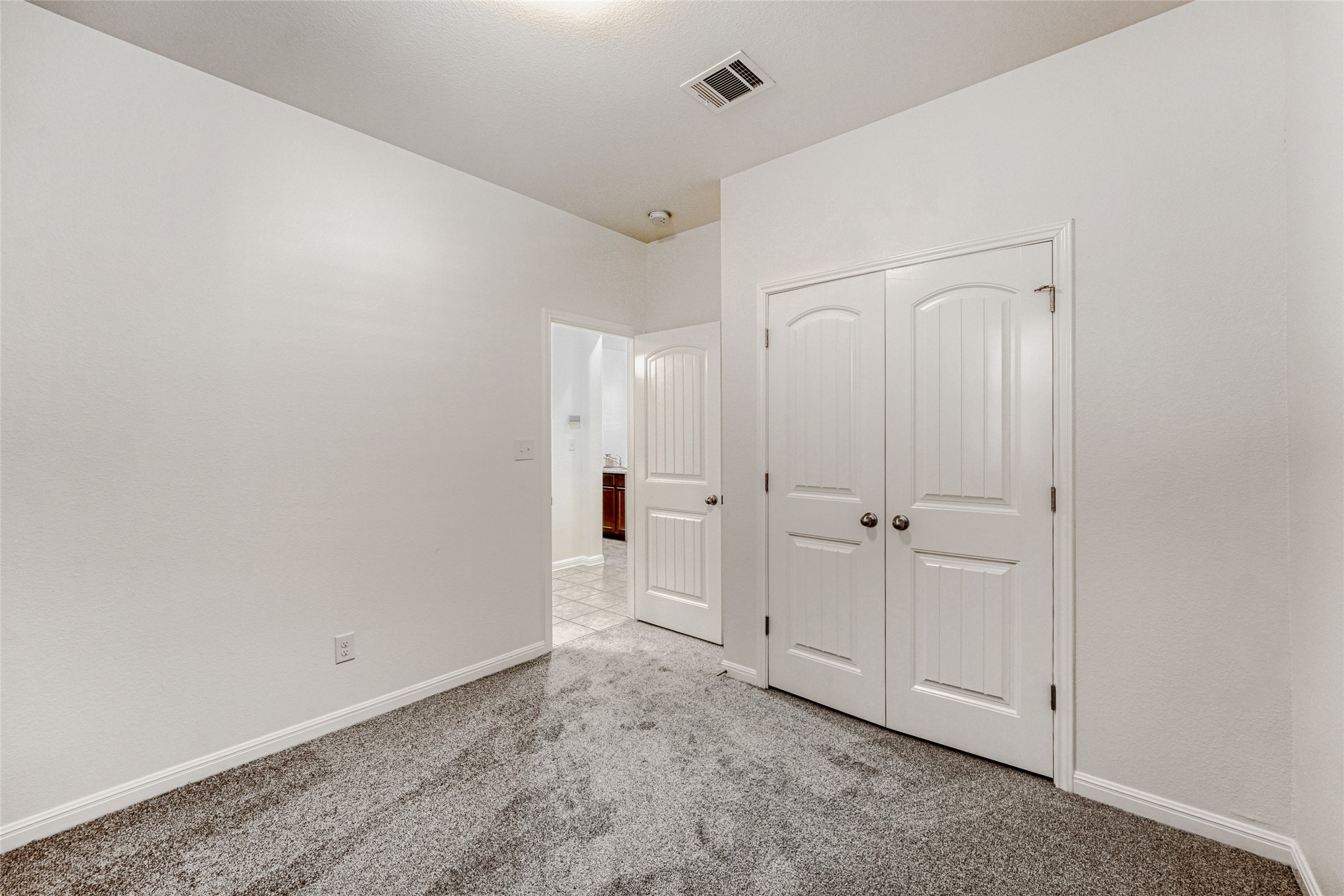 410 Anacua Loop, Unit 30 Manchaca, TX 78652 - Photo 26 of 33 Unfurnished bedroom #3 featuring carpet and a closet