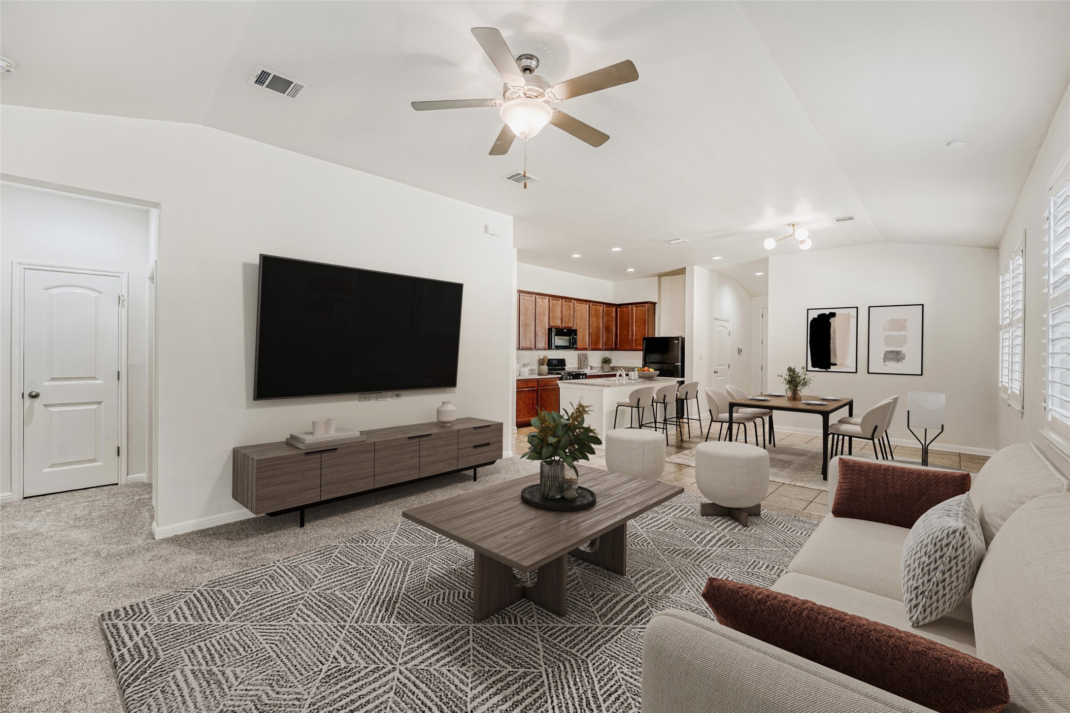 410 Anacua Loop, Unit 30 Manchaca, TX 78652 - Photo 3 of 33 Living room with vaulted ceiling, a ceiling fan, and light colored carpet