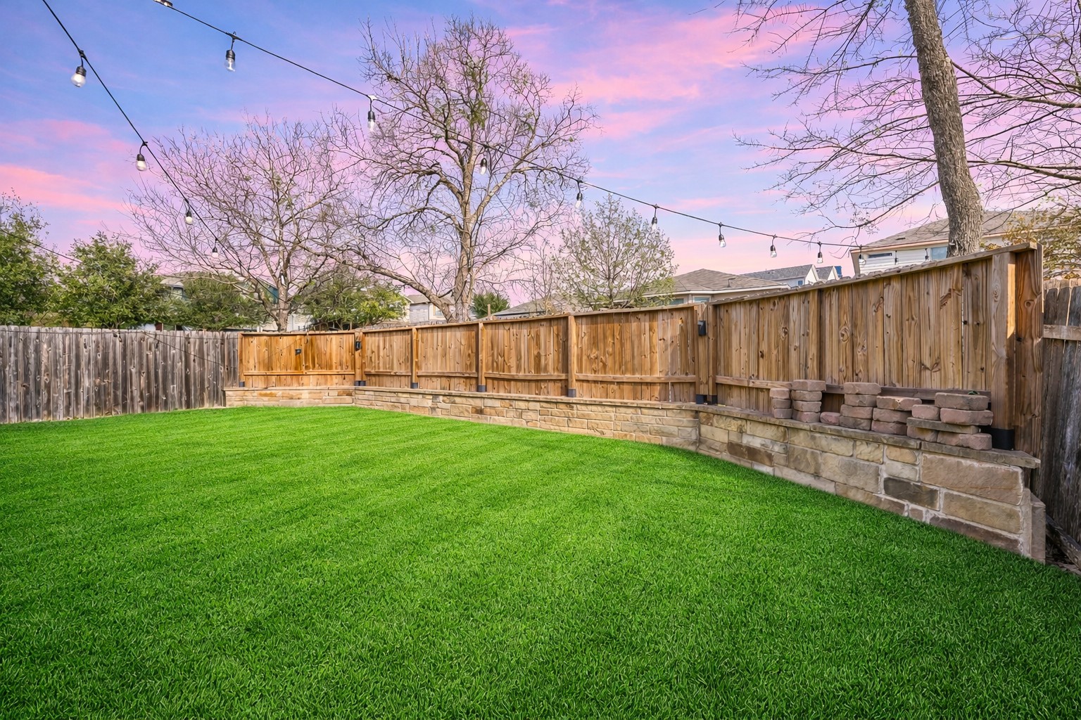 410 Anacua Loop, Unit 30 Manchaca, TX 78652 - Photo 6 of 33 Yard at dusk with a fenced backyard