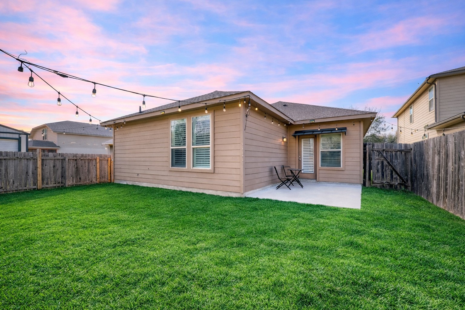 410 Anacua Loop, Unit 30 Manchaca, TX 78652 - Photo 7 of 33 Rear view of house with a fenced backyard, a patio area, and a gate