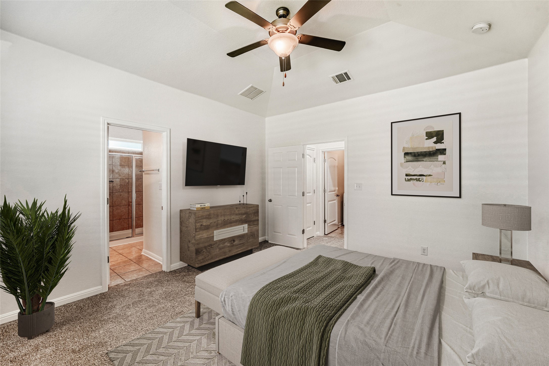 410 Anacua Loop, Unit 30 Manchaca, TX 78652 - Photo 10 of 33 Primary Bedroom with light colored carpet, ceiling fan, and connected full primary bathroom