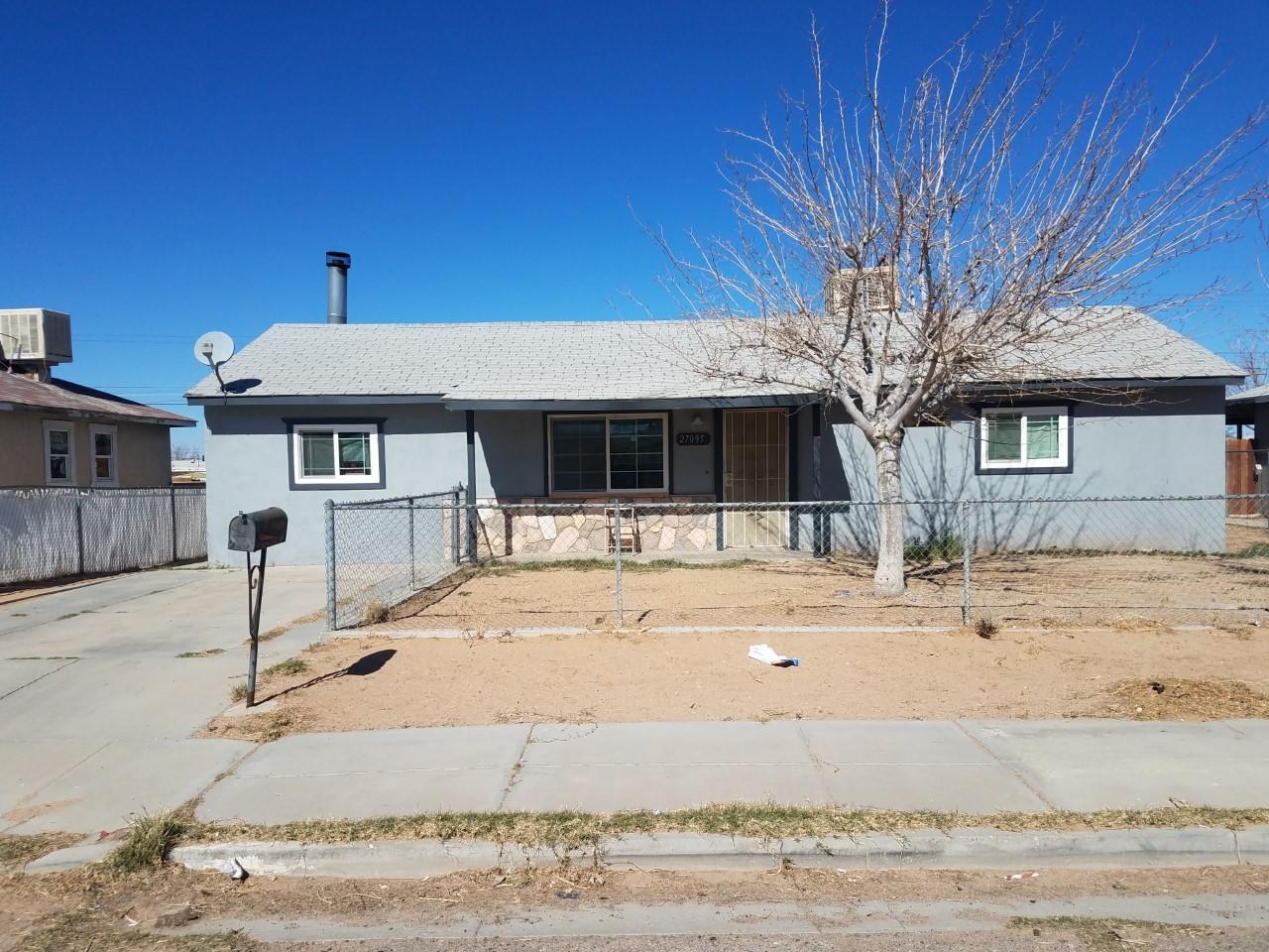 27095 Cote Street Boron, CA 93516 - Photo 1 of 15 a front view of a house with a yard