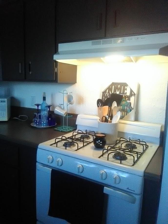 27095 Cote Street Boron, CA 93516 - Photo 2 of 15 a kitchen with a stove and a microwave