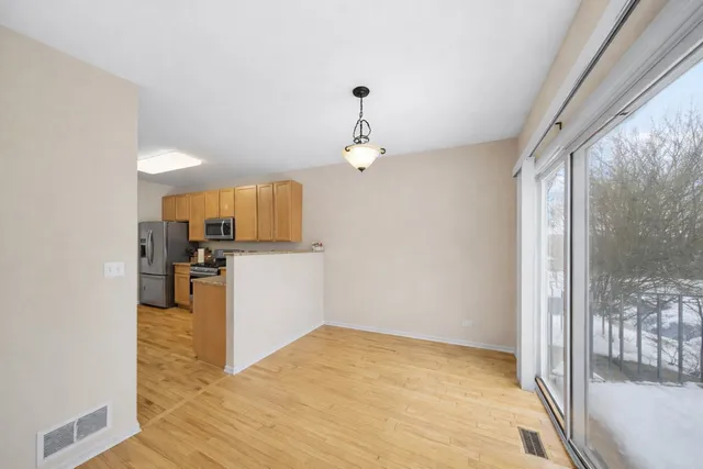 a view of a kitchen with a sink and a refrigerator
