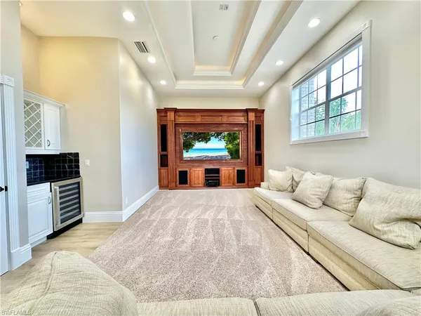 a living room with furniture a large window and a fireplace