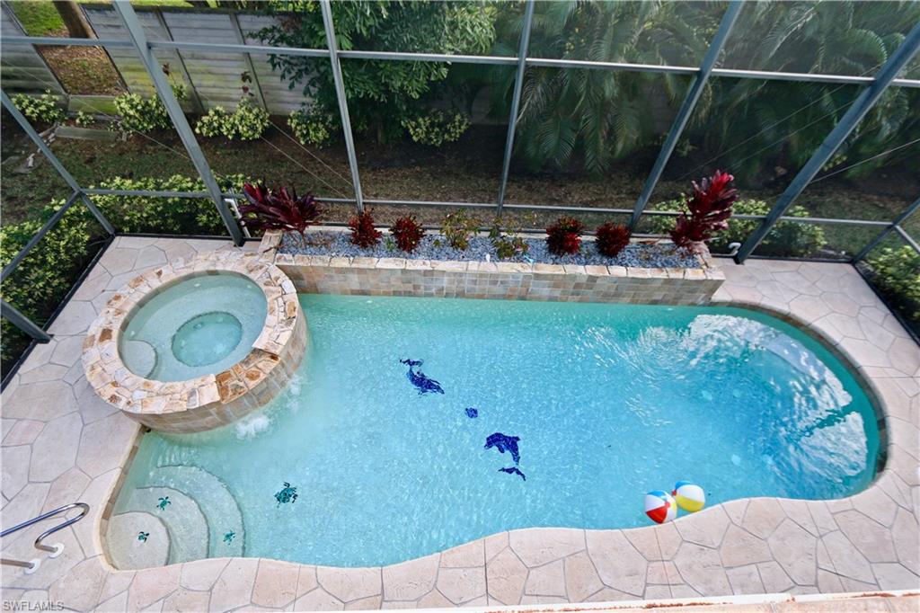 2855 Coach House Way Naples, FL 34105 - Photo 18 of 42 Relaxing pool / spa featuring glass enclosure and a patio