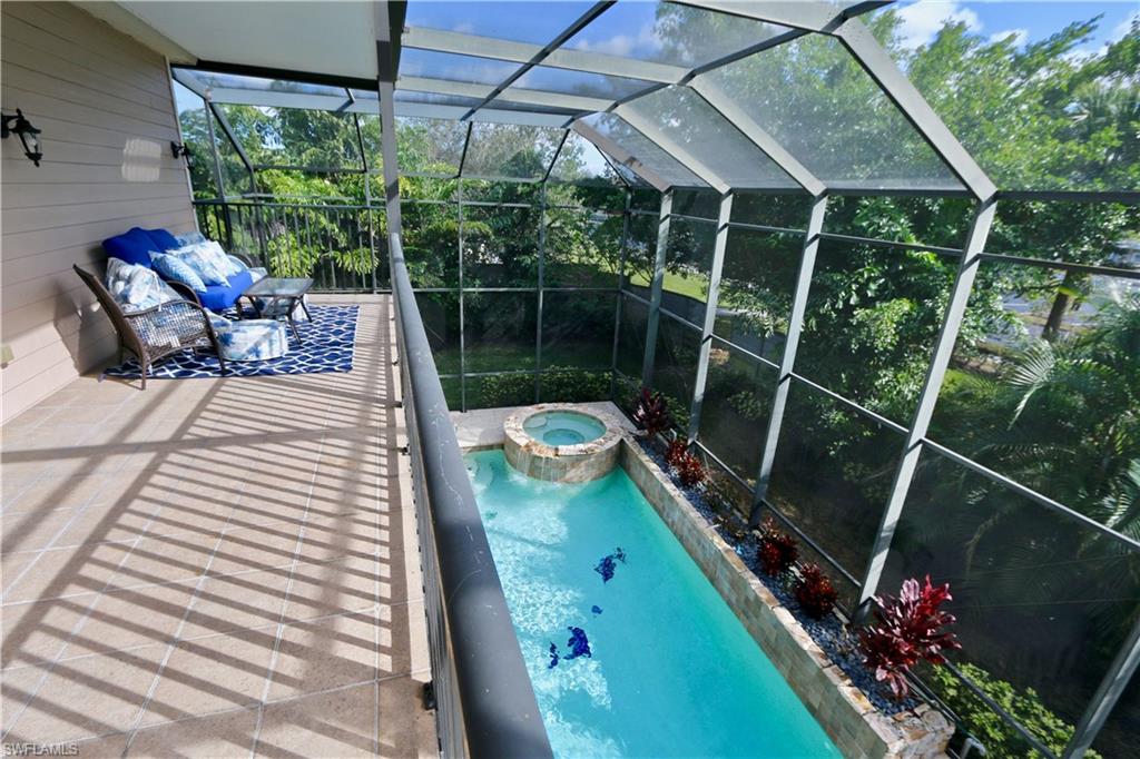 2855 Coach House Way Naples, FL 34105 - Photo 19 of 42 Integrated pool / hot tub featuring a sunroom and a lanai