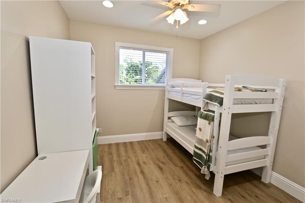 2855 Coach House Way Naples, FL 34105 - Photo 22 of 42 Bedroom with light wood-style flooring, a ceiling fan, and recessed lighting