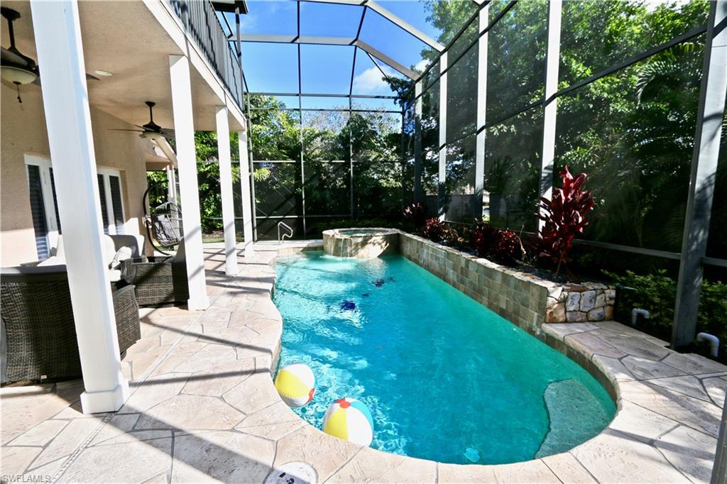 2855 Coach House Way Naples, FL 34105 - Photo 33 of 42 Combined pool / hot tub with a patio area, a lanai, and a sunroom