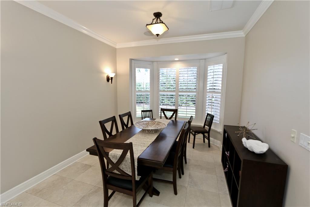2855 Coach House Way Naples, FL 34105 - Photo 39 of 42 Dining room with baseboards and ornamental molding