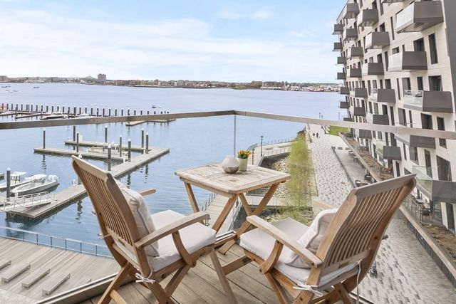 a view of a balcony with furniture and city view